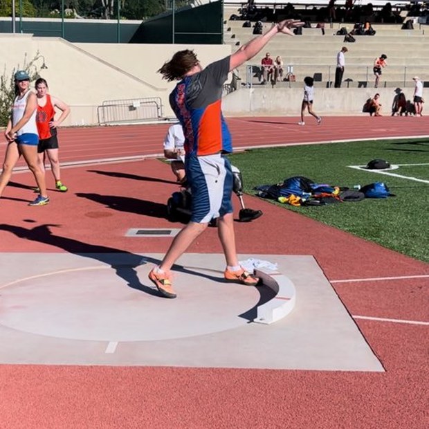 Ryan throwing shot put at a track meet